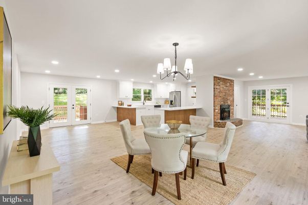 Chandelier, Dining room, Fireplace, Interior, Kitchen, Recessed Lighting, Stainless Steel Appliances, Stone Walls, Wood Texture Flooring