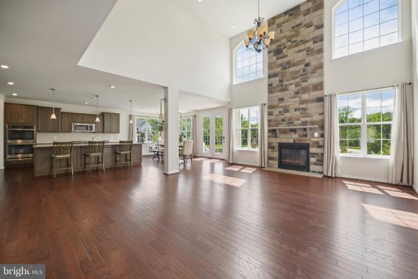 Chandelier, Dining room, Fireplace, Interior, Kitchen, Pendant Lights, Recessed Lighting, Stainless Steel Appliances, Stone Walls, Wood Texture Flooring