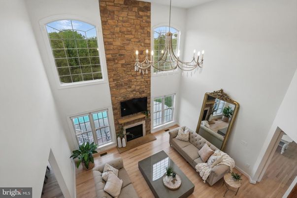Chandelier, Fireplace, Interior, Living room, Stone Walls, Wood Texture Flooring