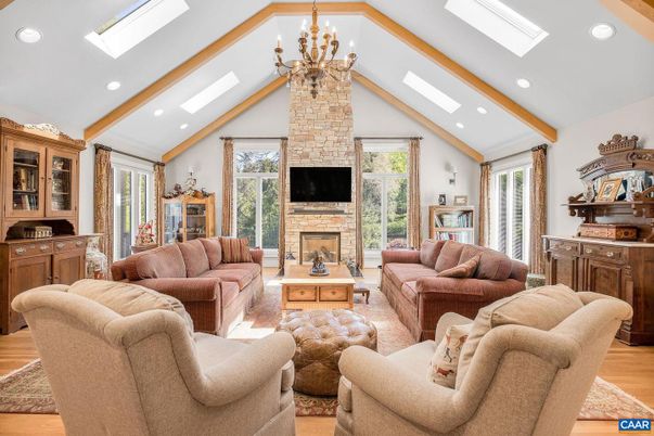Chandelier, Fireplace, Interior, Living room, Recessed Lighting, Stone Walls, Wood Texture Flooring