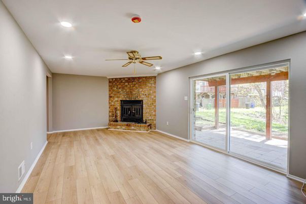 Empty room, Fireplace, Interior, Recessed Lighting, Stone Walls, Wood Texture Flooring