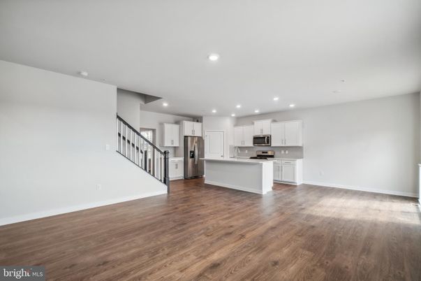 Empty room, Interior, Kitchen, Recessed Lighting, Stainless Steel Appliances, Wood Texture Flooring