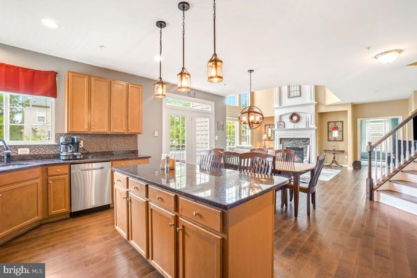 Chandelier, Dining room, Fireplace, Interior, Kitchen, Pendant Lights, Recessed Lighting, Stainless Steel Appliances, Wood Texture Flooring