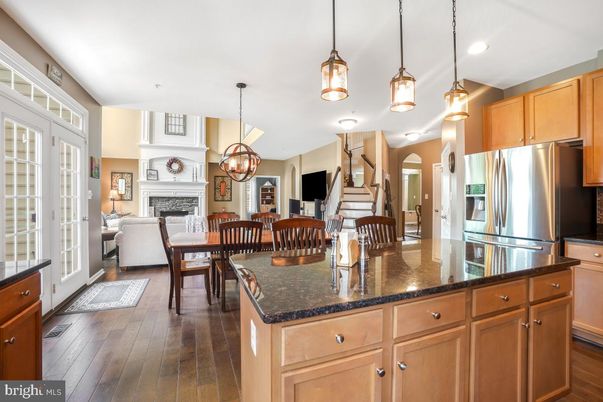 Chandelier, Dining room, Fireplace, Interior, Kitchen, Living room, Pendant Lights, Recessed Lighting, Stainless Steel Appliances, Wood Texture Flooring