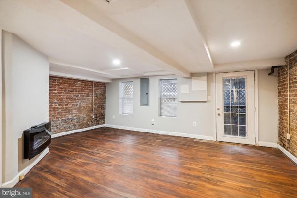 Empty room, Fireplace, Interior, Recessed Lighting, Stone Walls, Wood Texture Flooring