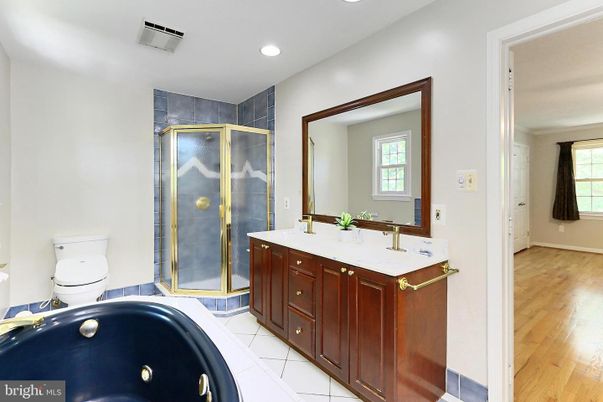 Bathroom, Dual Sink Vanities, Glass Shower, Interior, Recessed Lighting, Tile Countertops, Wood Texture Flooring