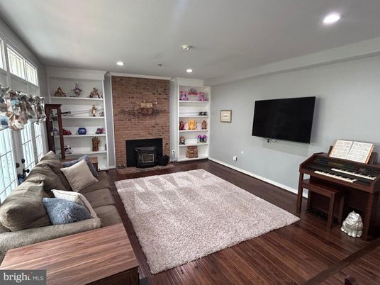 Fireplace, Interior, Living room, Piano, Recessed Lighting, Stone Walls, Wood Texture Flooring