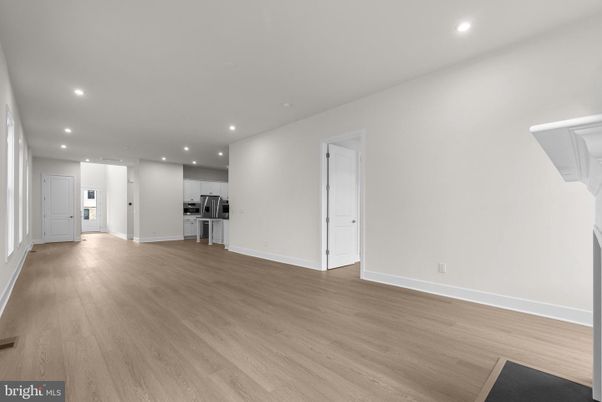 Empty room, Interior, Kitchen, Recessed Lighting, Stainless Steel Appliances, Wood Texture Flooring