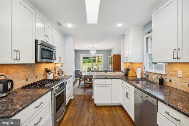 Chandelier, Dining room, Interior, Kitchen, Recessed Lighting, Stainless Steel Appliances, Wood Texture Flooring