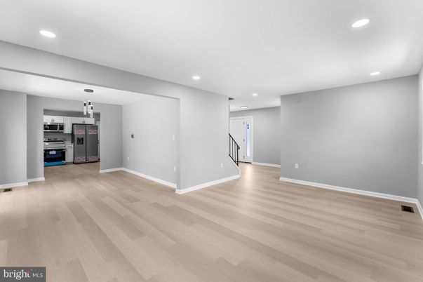 Empty room, Interior, Kitchen, Recessed Lighting, Stainless Steel Appliances, Wood Texture Flooring