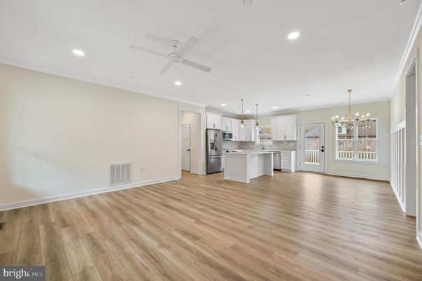 Empty room, Interior, Kitchen, Pendant Lights, Recessed Lighting, Stainless Steel Appliances, Wood Texture Flooring