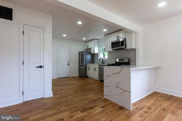 Interior, Kitchen, Marble Walls, Recessed Lighting, Stainless Steel Appliances, Wood Texture Flooring