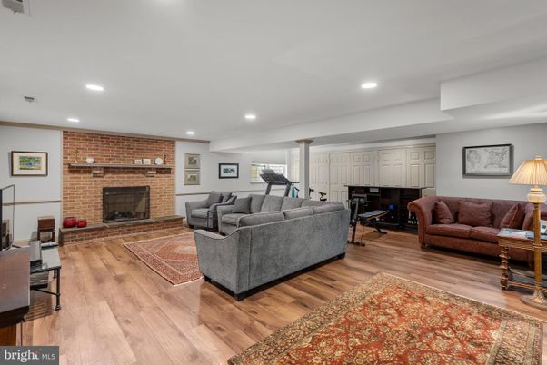 Fireplace, Fitness Equipment, Interior, Living room, Piano, Recessed Lighting, Stone Walls, Wood Texture Flooring