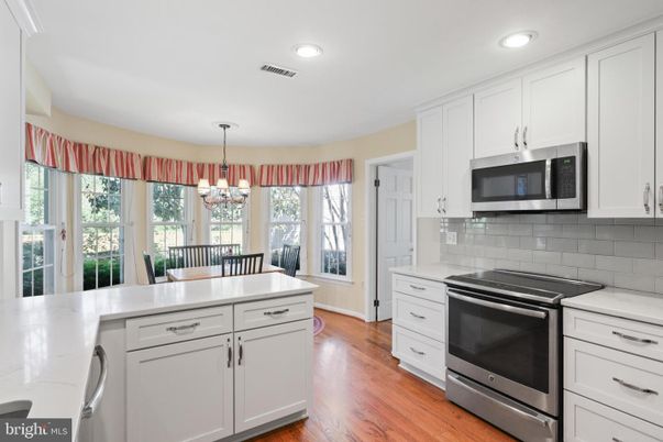 Chandelier, Dining room, Interior, Kitchen, Pendant Lights, Recessed Lighting, Stainless Steel Appliances, Wood Texture Flooring