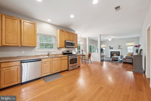 Dining room, Fireplace, Interior, Kitchen, Living room, Pendant Lights, Recessed Lighting, Stainless Steel Appliances, Wood Texture Flooring