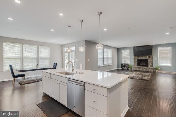 Dining room, Fireplace, Interior, Kitchen, Pendant Lights, Recessed Lighting, Stainless Steel Appliances, Wood Texture Flooring