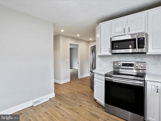 Interior, Kitchen, Marble Walls, Recessed Lighting, Stainless Steel Appliances, Wood Texture Flooring