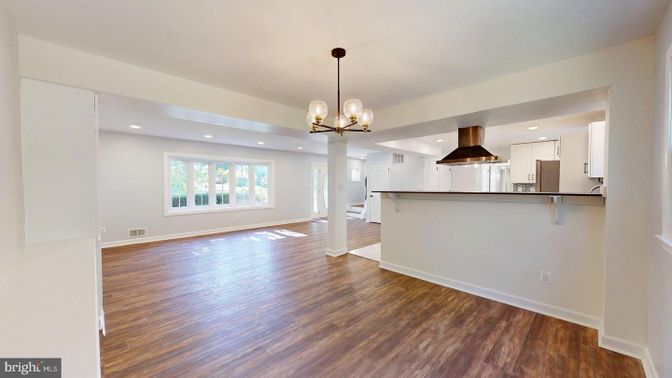 Empty room, Interior, Kitchen, Pendant Lights, Recessed Lighting, Stainless Steel Appliances, Wood Texture Flooring