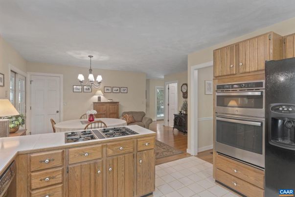 Chandelier, Dining room, Interior, Kitchen, Living room, Stainless Steel Appliances, Wood Texture Flooring