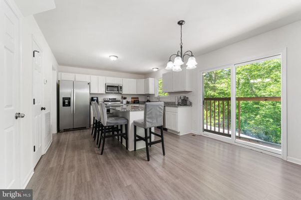 Chandelier, Dining room, Interior, Kitchen, Pendant Lights, Stainless Steel Appliances, Wood Texture Flooring