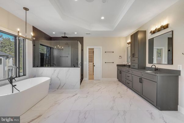 Bathroom, Dual Sink Vanities, Free Standing Baths, Interior, Marble, Marble Walls, Pendant Lights, Recessed Lighting