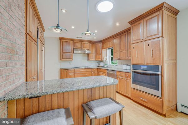 Interior, Kitchen, Pendant Lights, Recessed Lighting, Stainless Steel Appliances, Stone Walls, Wood Texture Flooring