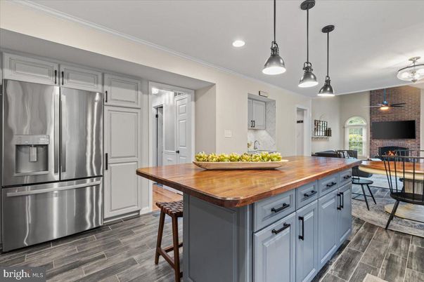 Dining room, Fireplace, Interior, Kitchen, Pendant Lights, Recessed Lighting, Stainless Steel Appliances, Stone Walls, Wood Texture Flooring