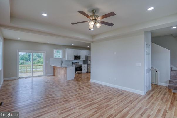 Empty room, Interior, Kitchen, Recessed Lighting, Stainless Steel Appliances, Wood Texture Flooring