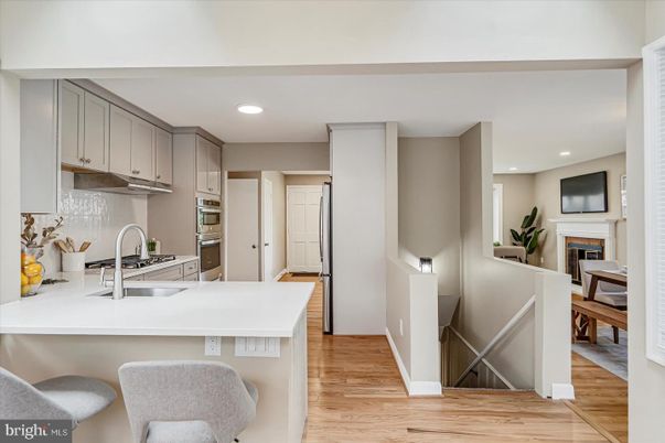 Fireplace, Interior, Kitchen, Recessed Lighting, Stainless Steel Appliances, Wood Texture Flooring
