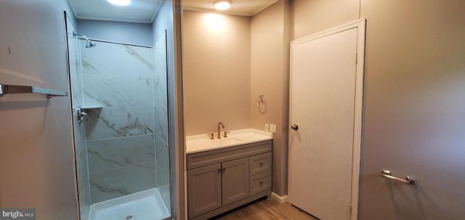 Bathroom, Glass Shower, Interior, Marble Walls, Recessed Lighting, Wood Texture Flooring