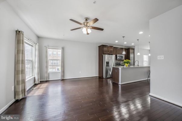 Empty room, Interior, Kitchen, Pendant Lights, Recessed Lighting, Stainless Steel Appliances, Wood Texture Flooring
