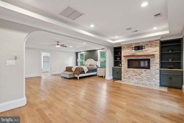 Bedroom, Fireplace, Interior, Recessed Lighting, Stone Walls, Wood Texture Flooring