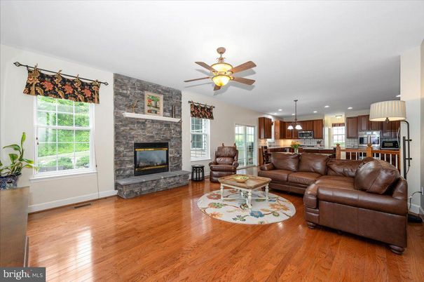 Fireplace, Interior, Kitchen, Living room, Pendant Lights, Recessed Lighting, Stainless Steel Appliances, Stone Walls, Wood Texture Flooring