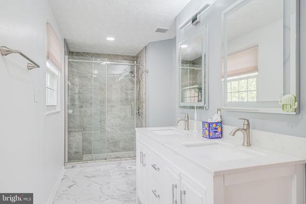 Bathroom, Dual Sink Vanities, Glass Shower, Interior, Marble, Marble Walls, Recessed Lighting