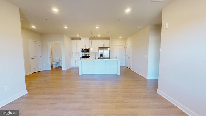 Empty room, Interior, Kitchen, Pendant Lights, Recessed Lighting, Stainless Steel Appliances, Wood Texture Flooring