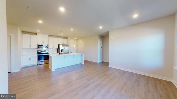 Empty room, Interior, Kitchen, Pendant Lights, Recessed Lighting, Stainless Steel Appliances, Wood Texture Flooring