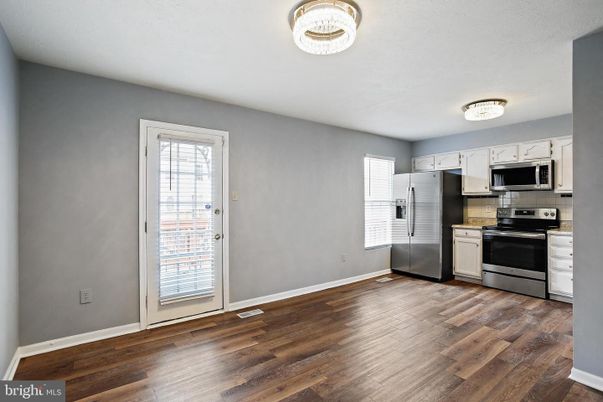 Empty room, Interior, Kitchen, Stainless Steel Appliances, Wood Texture Flooring