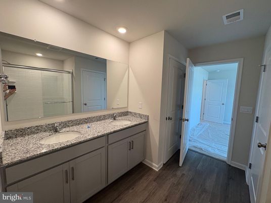 Bathroom, Dual Sink Vanities, Glass Shower, Interior, Recessed Lighting, Wood Texture Flooring