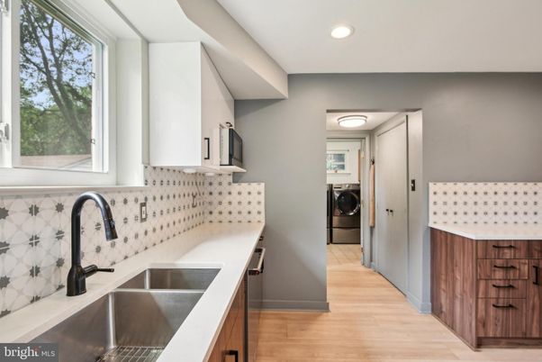 Interior, Kitchen, Recessed Lighting, Washer, Wood Texture Flooring