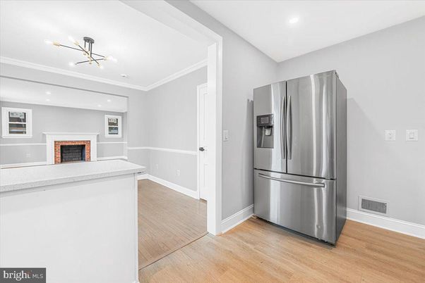 Fireplace, Interior, Kitchen, Recessed Lighting, Stainless Steel Appliances, Wood Texture Flooring
