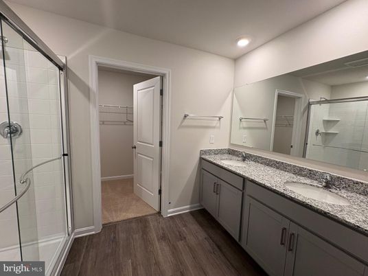 Bathroom, Dual Sink Vanities, Glass Shower, Interior, Recessed Lighting, Walk-in Closets, Wood Texture Flooring