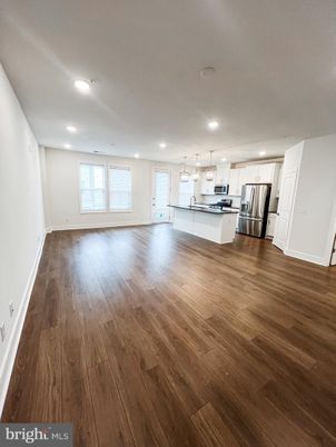 Empty room, Interior, Kitchen, Pendant Lights, Recessed Lighting, Stainless Steel Appliances, Wood Texture Flooring