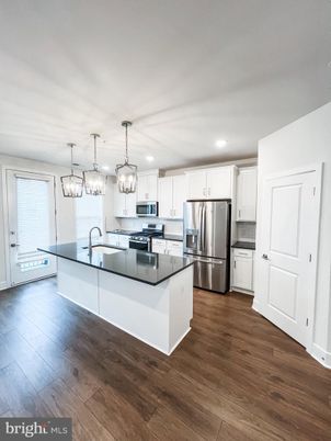Chandelier, Interior, Kitchen, Pendant Lights, Recessed Lighting, Stainless Steel Appliances, Wood Texture Flooring