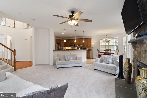 Chandelier, Dining room, Fireplace, Interior, Kitchen, Living room, Pendant Lights, Recessed Lighting, Stainless Steel Appliances