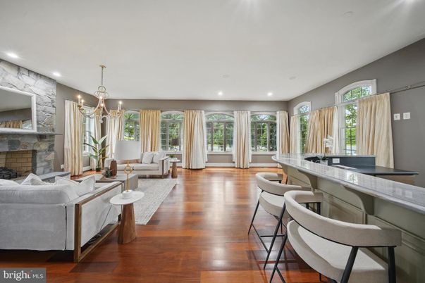 Chandelier, Fireplace, Interior, Living room, Recessed Lighting, Stone Walls, Wood Texture Flooring