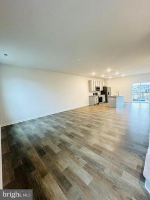 Empty room, Interior, Kitchen, Recessed Lighting, Stainless Steel Appliances, Wood Texture Flooring