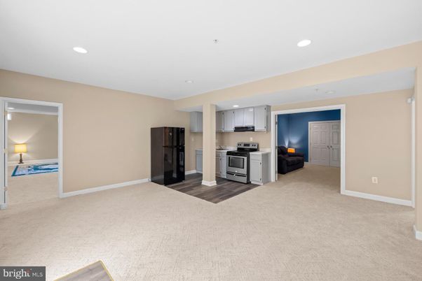 Empty room, Interior, Kitchen, Recessed Lighting, Stainless Steel Appliances, Wood Texture Flooring