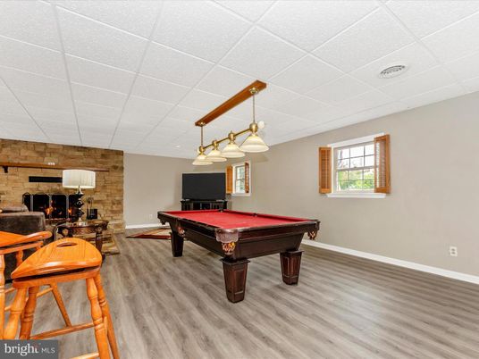 Billiard Table, Fireplace, Game Room, Interior, Pendant Lights, Stone Walls, Wood Texture Flooring