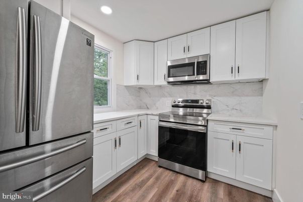 Interior, Kitchen, Marble Walls, Recessed Lighting, Stainless Steel Appliances, Wood Texture Flooring
