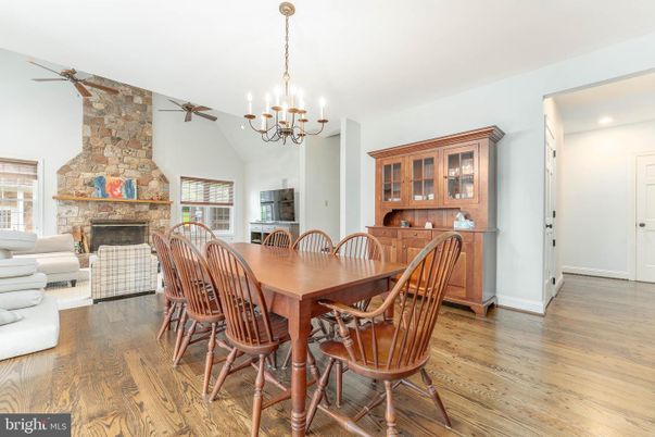 Chandelier, Dining room, Fireplace, Interior, Living room, Recessed Lighting, Stone Walls, Wood Texture Flooring
